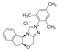 (5aS,10bR)-5a,10b-Dihydro-2-(2,4,6-trimethylphenyl)-4H, 6H-indeno[2,1-b]-1,2,4-triazolo[4,3-d]-1,4-oxazinium chloride monohydrate 